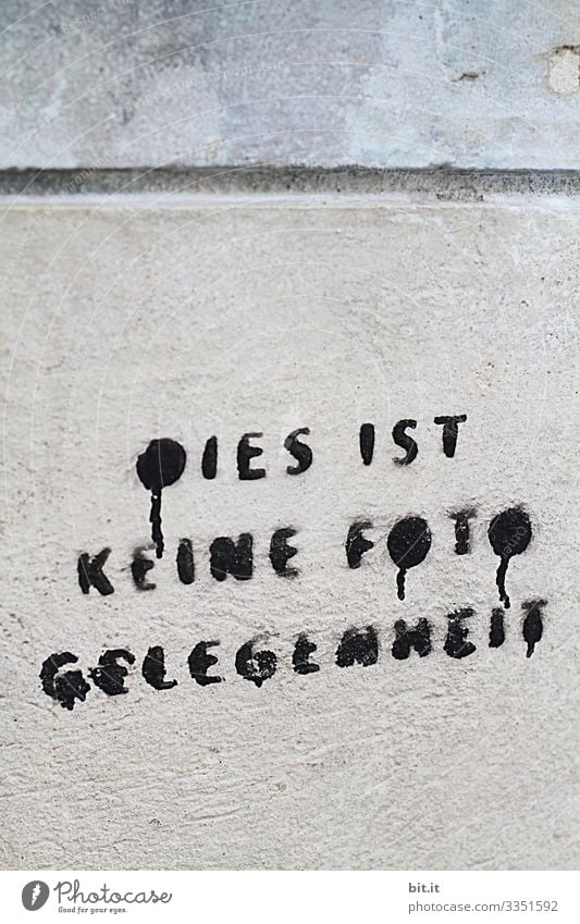 Writing: This is not a photo opportunity, stands sprayed, painted in black letters on a stone wall, written on a house. Caution, prohibition to take pictures, as a hint. Photography prohibited.