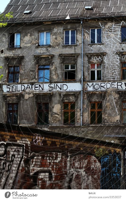 Writing: Soldiers are murderers, is written on an occupied house as a motto, slogan. War. Crime. House (Residential Structure) Facade Sign Characters