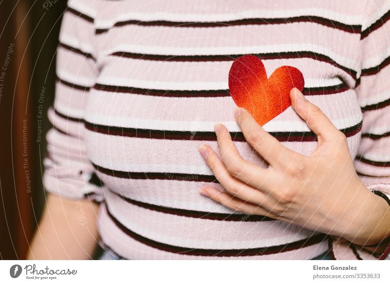 woman with red heart shaped cardboard near the breast. Feasts & Celebrations Valentine's Day Office work Human being Woman Adults Youth (Young adults) Breasts