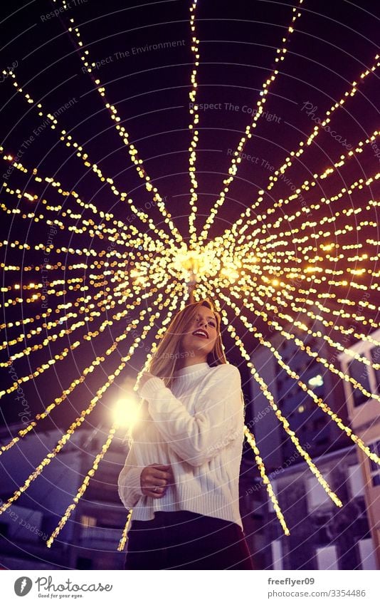 Young woman enjoying the Christmas decoration in Vigo, Galicia, Spain vigo galicia christmas lighting lights bokeh young exterior scene outside seasonal blue