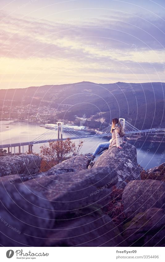 Young woman contemplating Vigo from the best bench of the world contemplation Galicia Spain tourism hiking altitude rande bridge ria Pontevedra travel adventure