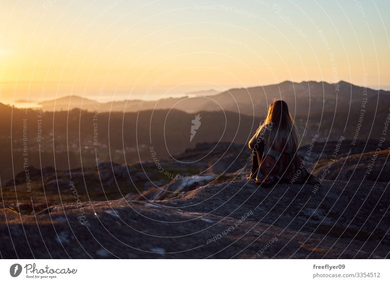 Young woman contemplating the sunset from Mount Galiñeiro in Vigo, Galicia, Spain alps idyllic nature feet mountains morning romantic meadow serene calm