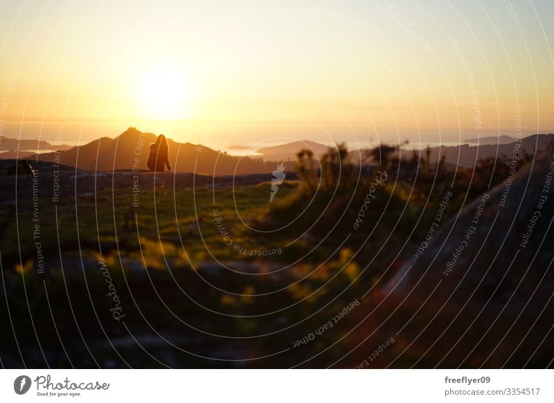 Young woman contemplating the sunset from Mount Galiñeiro in Vigo, Galicia, Spain alps idyllic nature feet mountains morning romantic meadow serene calm