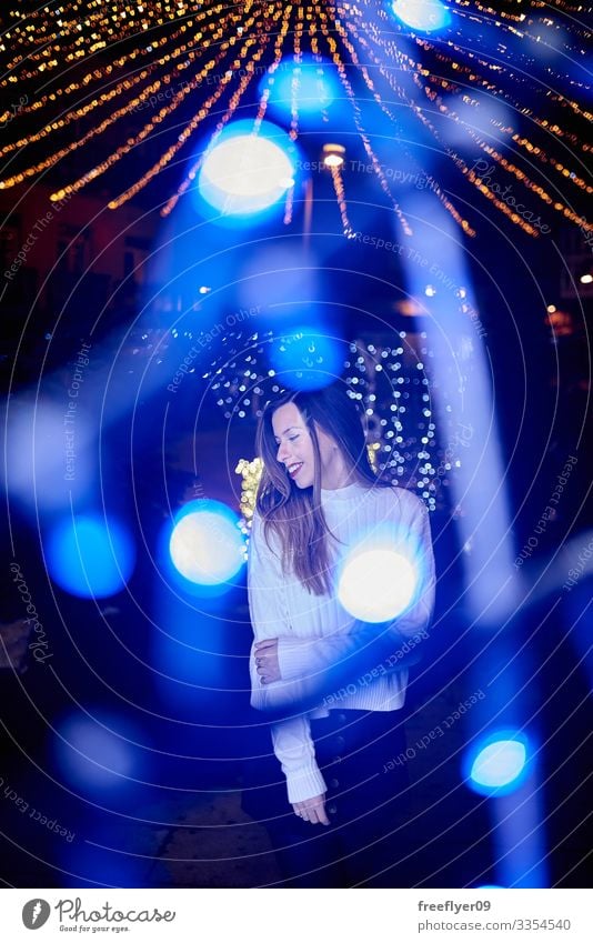 Young woman enjoying the Christmas decoration in Vigo, Galicia, Spain vigo galicia christmas lighting lights bokeh young exterior scene outside seasonal blue