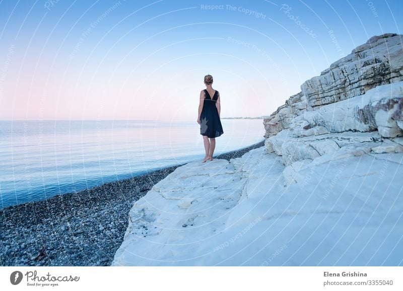 A lonely girl in a black dress on the seashore. White rocks. Beautiful Ocean Woman Adults 18 - 30 years Youth (Young adults) Nature Landscape Summer