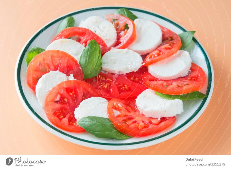 Caprese salad in brown background Cheese Vegetable Herbs and spices Nutrition Eating Diet Plate Table Fresh Red White Tradition Basil caprese salad Cooking food