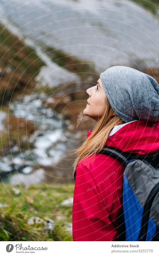 Tourist with backpack walking among path rocks woman tourist peak female mountain hill travel nature trekking landscape sky tourism adventure dangerous extreme