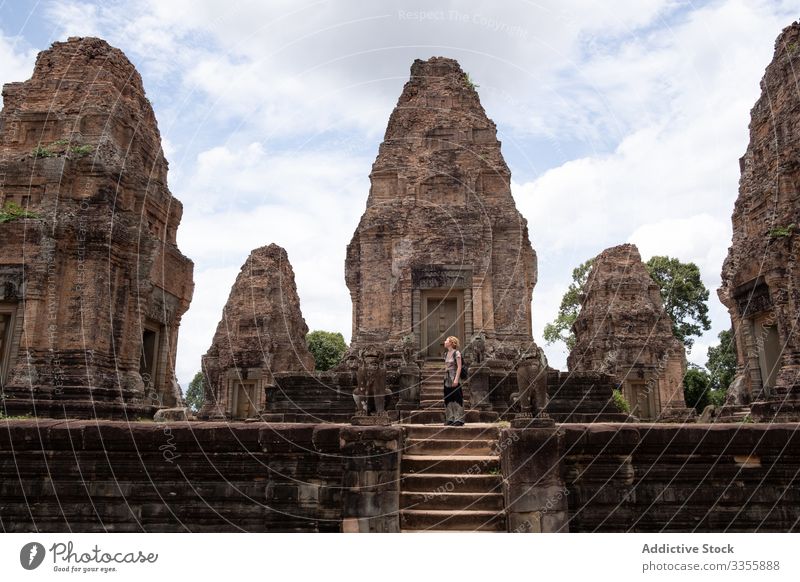 Faceless female traveler sightseeing ancient temple woman ruin religious tourist enjoy journey hindu landmark architecture tourism culture building historical