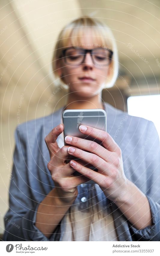 Businesswoman with smartphone businesswoman stylish young mobile connection cheerful handrail leaning female professional person beautiful using browsing