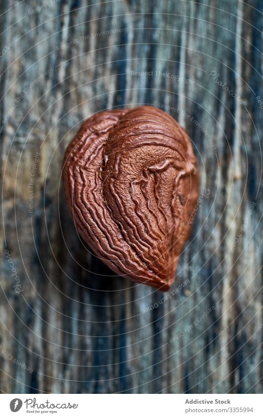 Half peeled hazelnut on table brown harvest ripe half wooden filbert gathering heap ingredient natural organic edible healthy raw seed food snack tasty seasonal