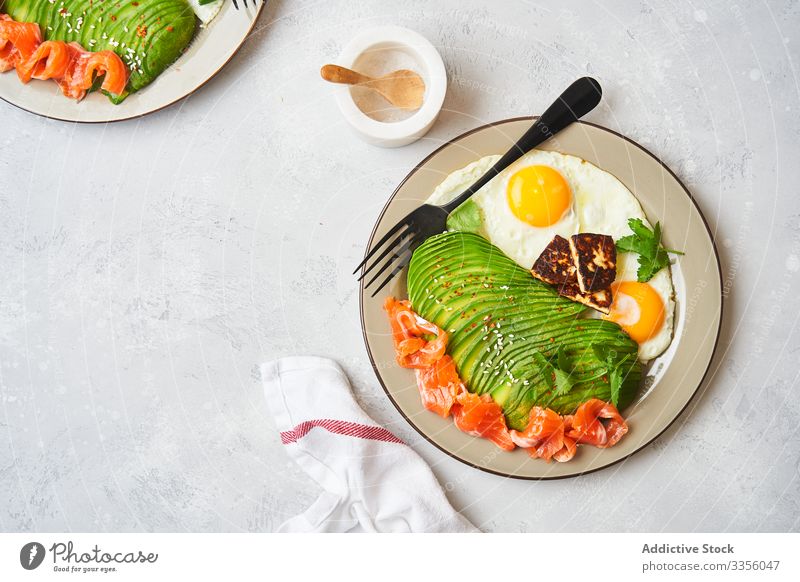 Healthy breakfast with fried eggs and avocado plate salmon fresh healthy food natural fish dish slice appetizing culinary brunch diet vegetarian ingredient