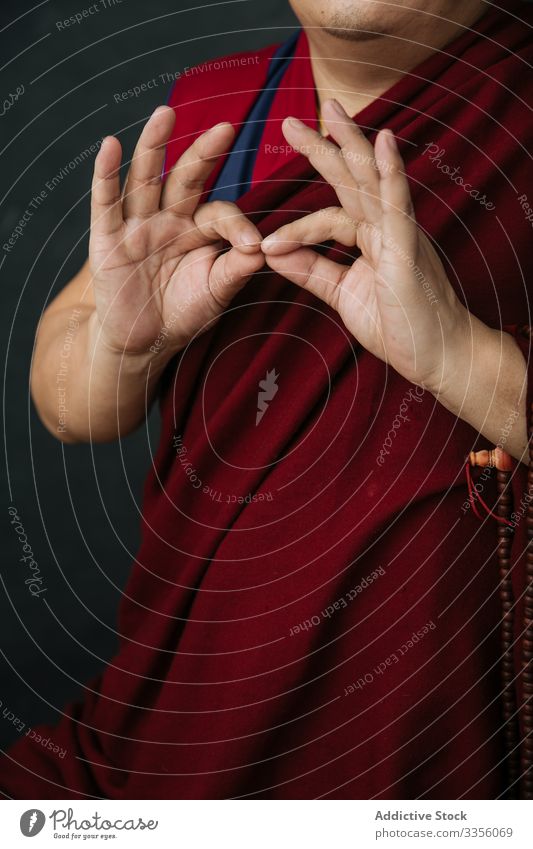 Buddhist monk with mudra hands gesture buddhist pray religion symbol traditional tibet red culture spirituality faith belief asia authentic holy sacred mantra