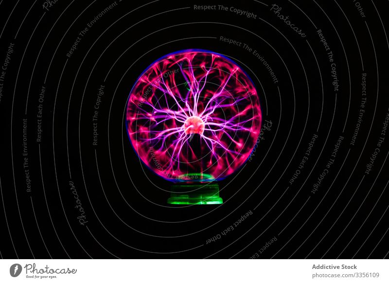 Light streams of light in luminous ball in dark neon electric lamp illuminated electricity glow energy bulb bright shiny power center illumination beautiful