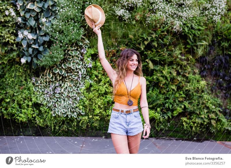 portrait of a young blonde beautiful woman at the street smiling. Green vegetation background. Lifestyle outdoors. Summertime Modern Hip & trendy Eroticism