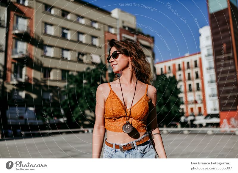 Beautiful young caucasian woman walking at the city street on a sunny day. Happy face smiling. Urban lifestyle Day Street Woman Sunbeam Cheerful Model