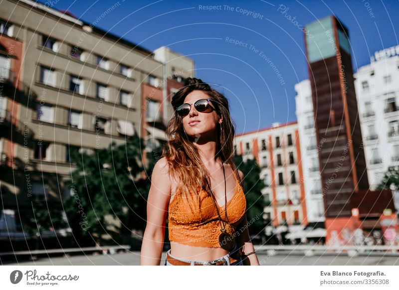 Beautiful young caucasian woman walking at the city street on a sunny day. Happy face smiling. Urban lifestyle Day Street Woman Sunbeam Cheerful Model