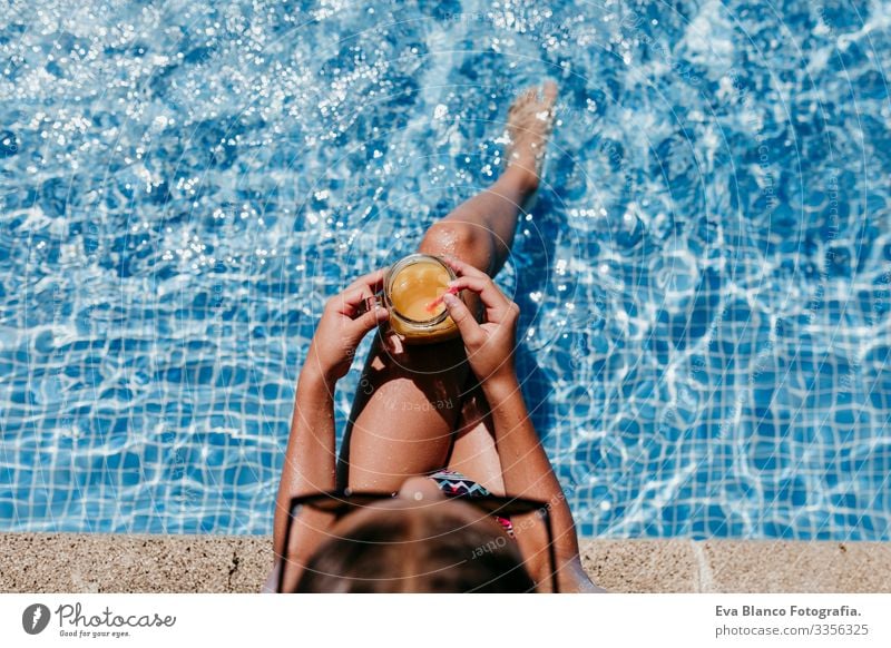 beautiful kid girl at the pool, summer time Sunlight Day orange drink Exterior shot young Swimwear water enjoyment swimming kids Caucasian Playful Blue Smiling