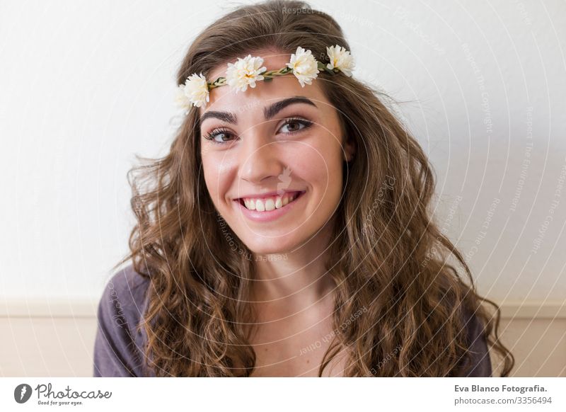 portrait of a young beautiful woman wearing a flowers wreath. She is smiling, indoors. Lifestyle Head Elegant Amazing Aromatic Considerate Eroticism Model