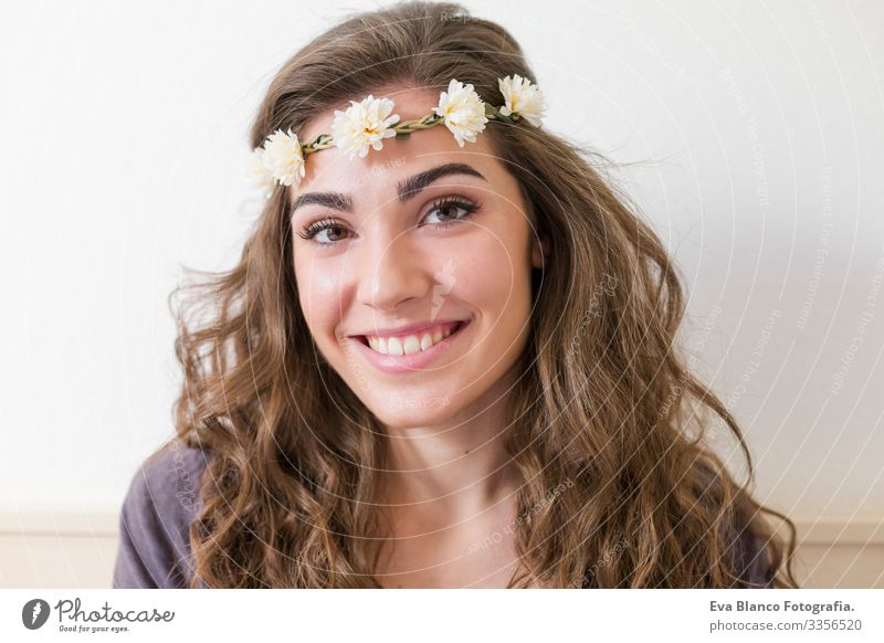 portrait of a young beautiful woman wearing a flowers wreath. She is smiling, indoors. Lifestyle. Horizontal view Head Elegant Amazing Aromatic Considerate