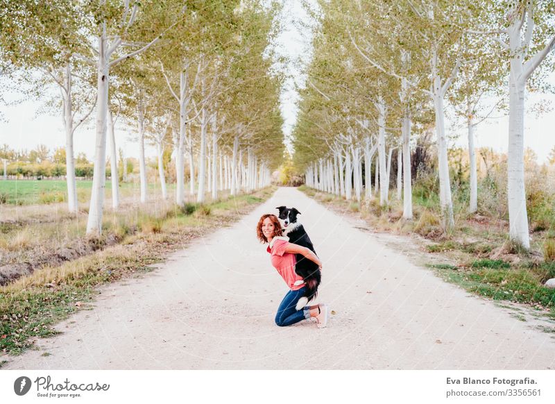 young woman training outdoors with her cute border collie dog in a trees path. Woman Dog Van Vacation & Travel Traveling owner Youth (Young adults) Modern