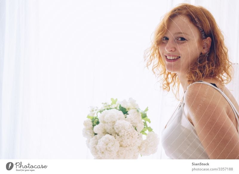 Portrait of redhead beautiful woman sitting near window at home Beautiful Skin Face Make-up Human being Woman Adults Flower Fashion Red-haired Smiling Eroticism