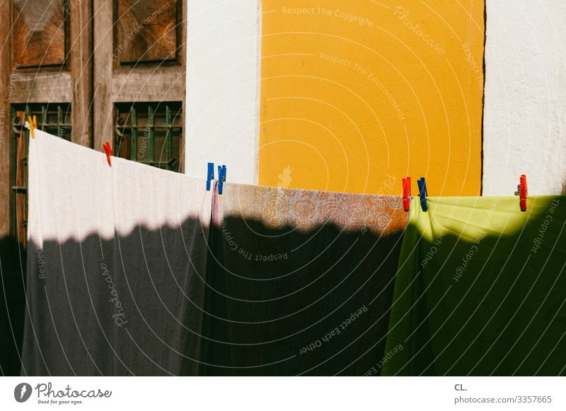 clothesline Wall (barrier) Wall (building) Laundry Clothesline Clothes peg Towel Esthetic Happiness Warmth Multicoloured Dry Colour photo Exterior shot Deserted