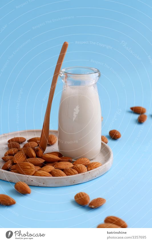 Vegan almond milk, non dairy alternative milk Vegetable Nutrition Vegetarian diet Diet Beverage Bottle Spoon Fresh Natural Blue Alternative almonds Vegan diet