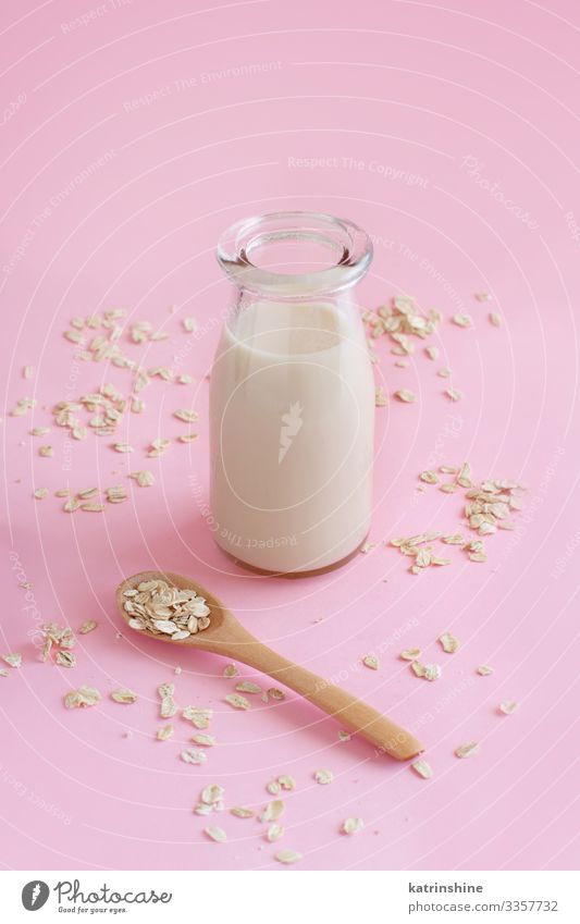 Vegan oat milk, non dairy alternative milk Vegetable Nutrition Breakfast Vegetarian diet Diet Beverage Bottle Spoon Table Fresh Natural Pink Alternative Oats