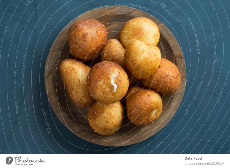 Colombian buñuelo - Deep Fried Cheese Bread Diet about view black background colombian copy spaces food Frying spaces for text sweet tradicional wooden plate