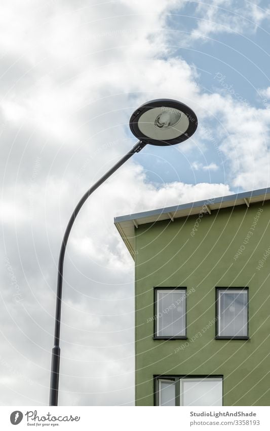 Streetlamp and facade of a green house Lifestyle House (Residential Structure) Lamp Environment Sky Clouds Town Building Architecture Facade Simple Modern New