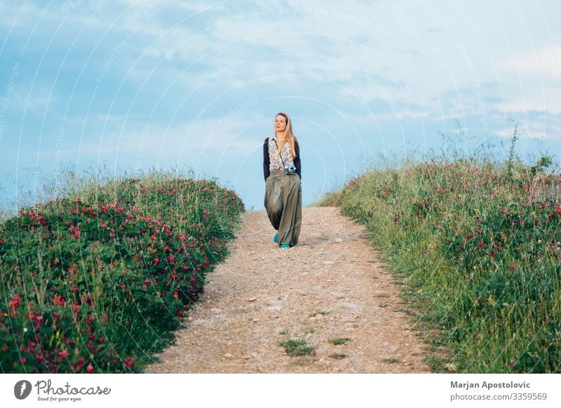 Young woman walking in countryside in Tuscany, Italy Lifestyle Vacation & Travel Tourism Trip Adventure Freedom Camera Feminine Youth (Young adults) Woman