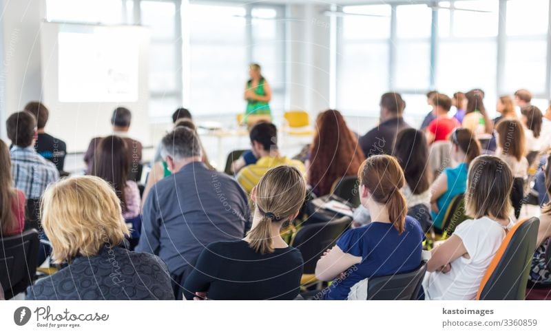 Speaker giving presentation on business conference. Audience Adult Education Academic studies Lecture hall Business Meeting To talk Woman Adults Group Society