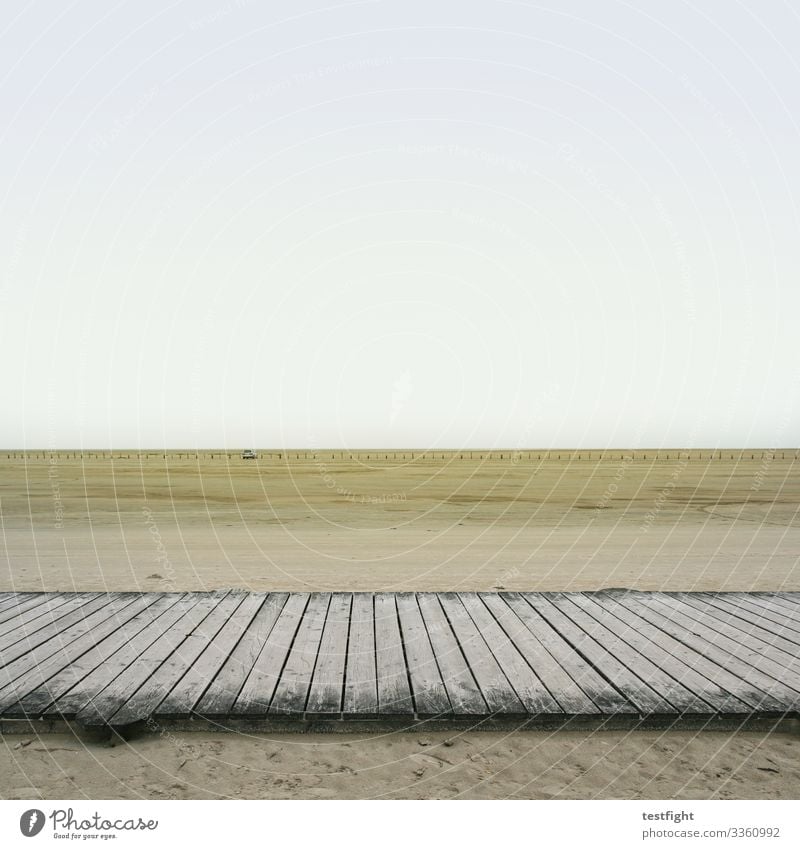 jetty on tidal flats Beach North Sea watt Mud flats Nature afar wide Minimalistic Low tide Sand Slick Damp Gray people persons Weather Climate Climate change