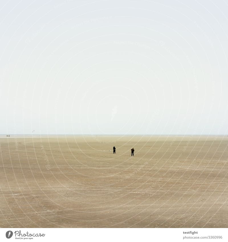 vast country Beach North Sea watt Mud flats Nature afar wide Minimalistic Low tide Sand Slick Damp Gray people persons Weather Climate Climate change Landscape