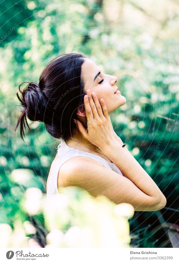 Portrait of a young beautiful girl in a white dress. Joy Young woman Youth (Young adults) 18 - 30 years Adults Beautiful weather Bushes Dress Brunette