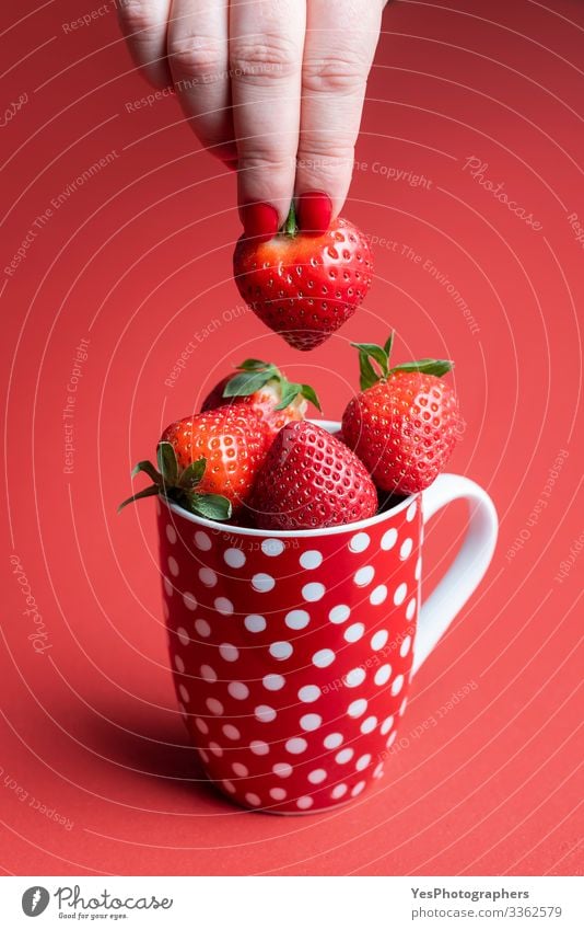 Taking a ripe strawberry from a pile. Cup of strawberries Food Fruit Dessert Candy Nutrition Breakfast Organic produce Mug Healthy Eating Feminine Hand