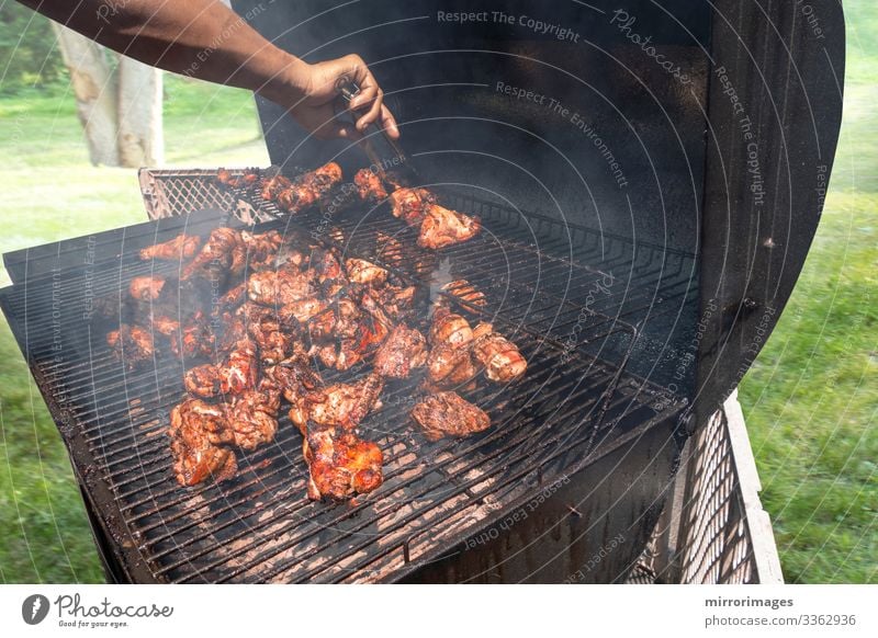 charcoal grill Suburban man grilling chicken for friends family Meat Lunch Dinner Organic produce Lifestyle Healthy Eating Summer Event Feasts & Celebrations