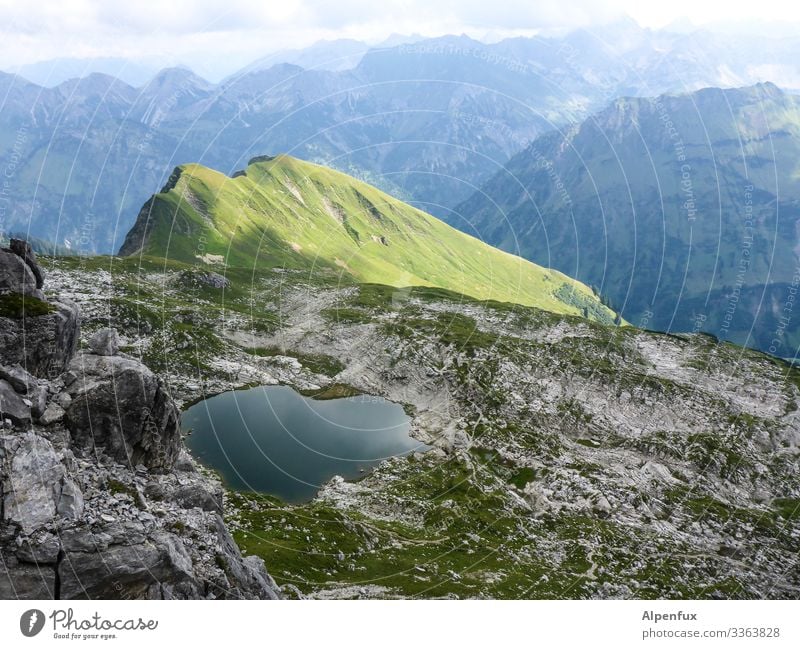 green spot hillock Mountain Landscape mountain lake Colour photo Sky Exterior shot Deserted Alps Lake Day Nature Environment Water Mountain range Summer Clouds