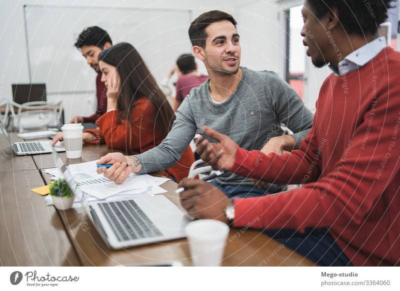 Young creative designers working in a project and discussing new order development on workplace. Business concept. Table Work and employment Profession Company