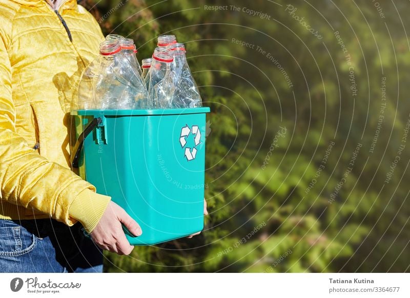 Girl's hands hold a box with empty plastic bottles. Bottle Industry Arm Hand Environment Earth Container Tin Plastic Clean Blue Green Black White