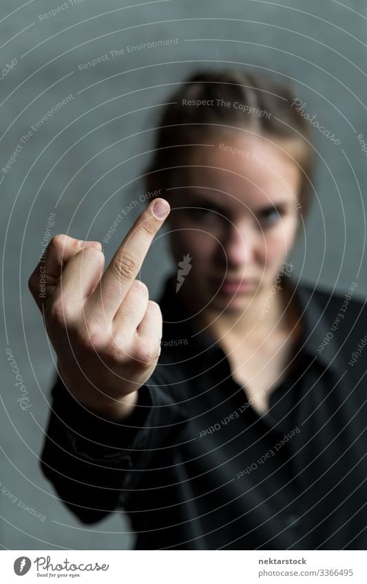 Young Woman Giving the Middle Finger middle finger female girl woman young adult youth culture day female beauty brown hair 1 person caucasian ethnicity