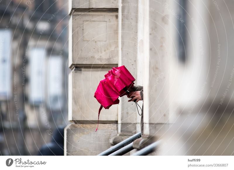 red umbrella Human being Hand 1 Bad weather Rain Building Villa Wall (barrier) Wall (building) Facade Umbrella Handrail Wait Fresh Wet Natural Red Serene