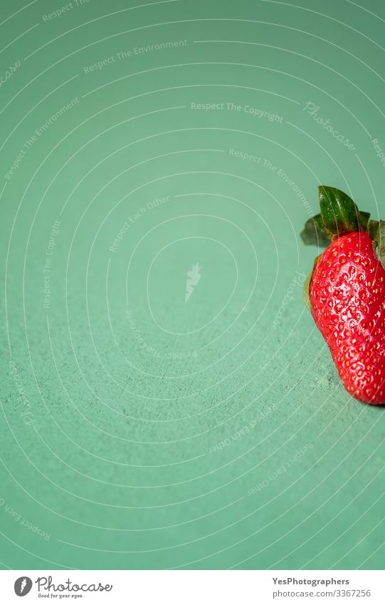 One strawberry on green table. Part of a strawberry close-up Fruit Dessert Organic produce Vegetarian diet Diet Fresh Natural Cute Sweet Green Red agriculture