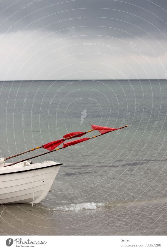 back in time Horizon boat Fishing boat Flags Ocean Sky thundercloud Water Wet Maritime fish Red White Gray Waves Beach Flagpole Coast Watercraft