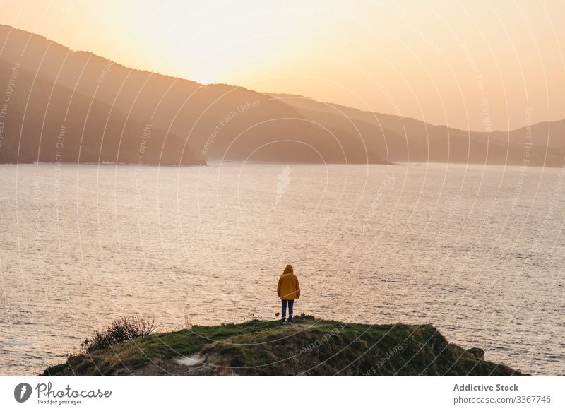 Tourist standing on hill and contemplating wonderful landscape man tourism sea ocean shore coast mountain vacation journey spain water trip travel wanderlust