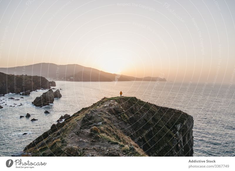 Tourist standing on hill and contemplating wonderful landscape man tourism sea ocean shore coast mountain vacation journey spain water trip travel wanderlust