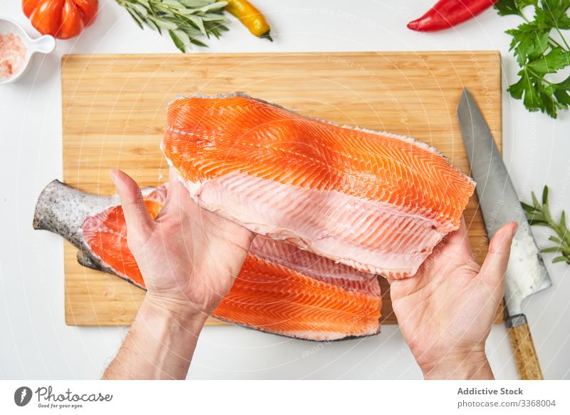 Process of butchering of fresh fish cooking process seafood raw salmon cutting knife chef ingredient herb spices peppers season table cuisine restaurant kitchen