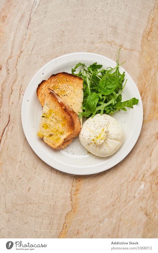 Simple high cuisine dish with bread restaurant roasted arugula dough stuffed platter simple table setting salad slice herb sauce stylish elegant haute cuisine