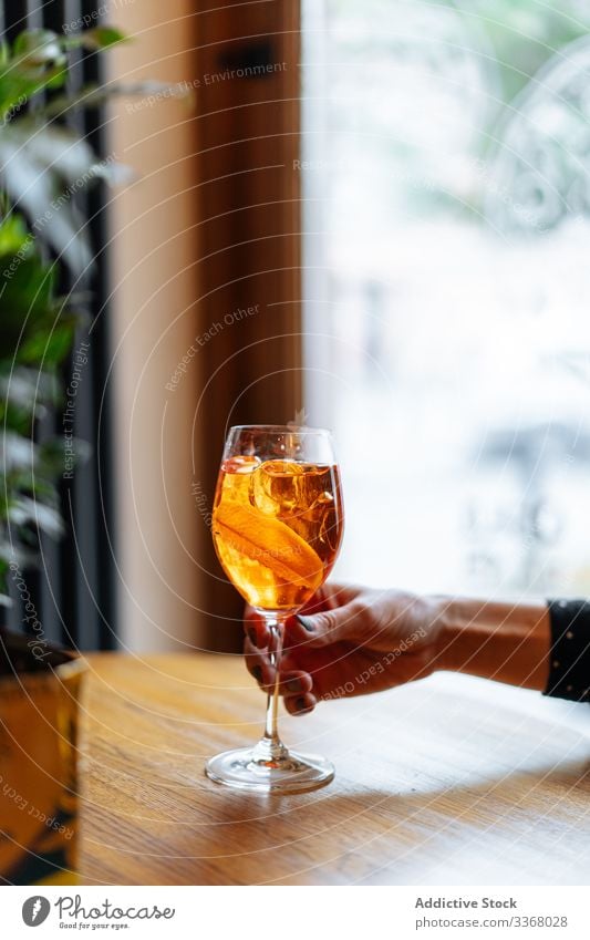 Spritz cocktail in female hand drink beverage alcohol restaurant spritz aperol campari slice orange woman lady arm modern glass stylish classy elegant pub bar