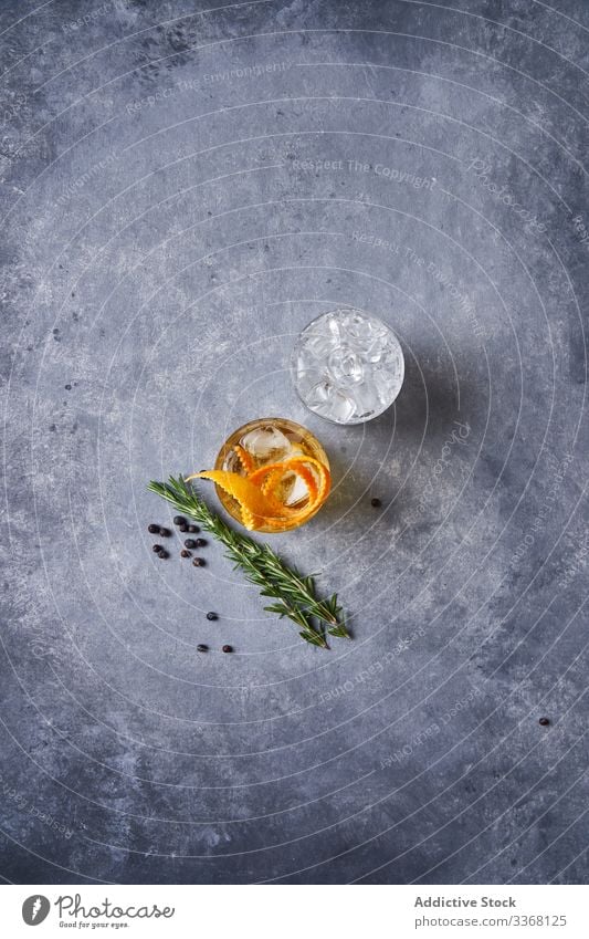 Old fashioned cocktail on table in pub old fashioned bar alcohol whiskey peel orange drink glass cup beverage ice cold cool classic liquor citrus refreshment